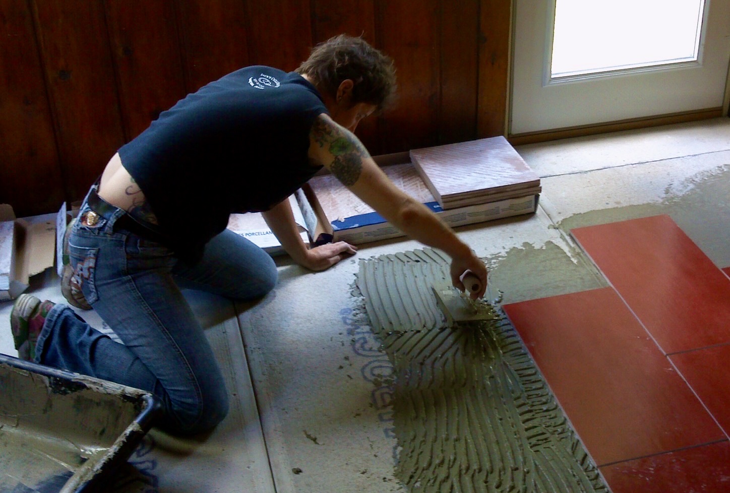 woman tiling a floor