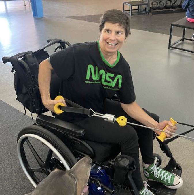 woman in a wheelchair exercising